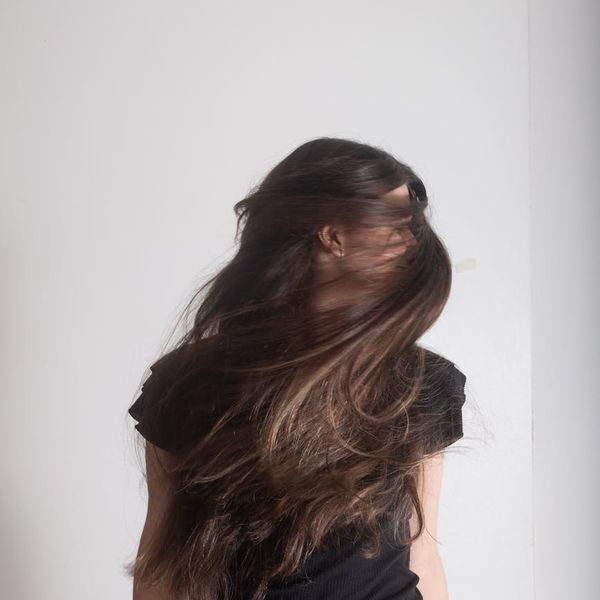 Silhouette of a woman in a flowing, dynamic pose, suggesting movement and energy.